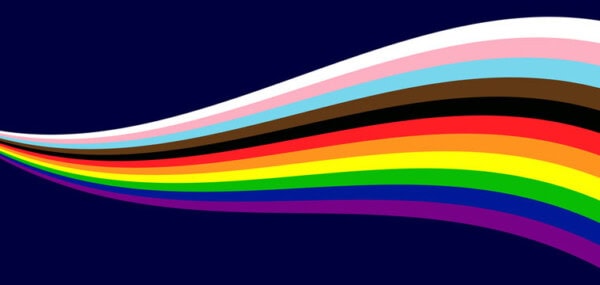A flowing wave of stripes in colors of the Progress Pride Flag—red, orange, yellow, green, blue, purple, black, brown, light blue, pink, and white—on a dark blue background.