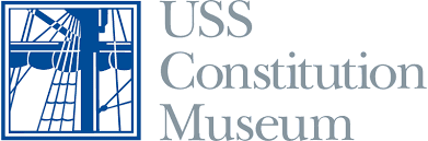 Logo for the USS Constitution Museum featuring a blue and white illustration of a ship’s rigging within a square, next to the text “USS Constitution Museum” in gray capital letters.