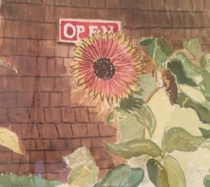 A sunflower with green leaves stands in front of a brown shingled wall, above which a red and white OPEN sign is displayed.